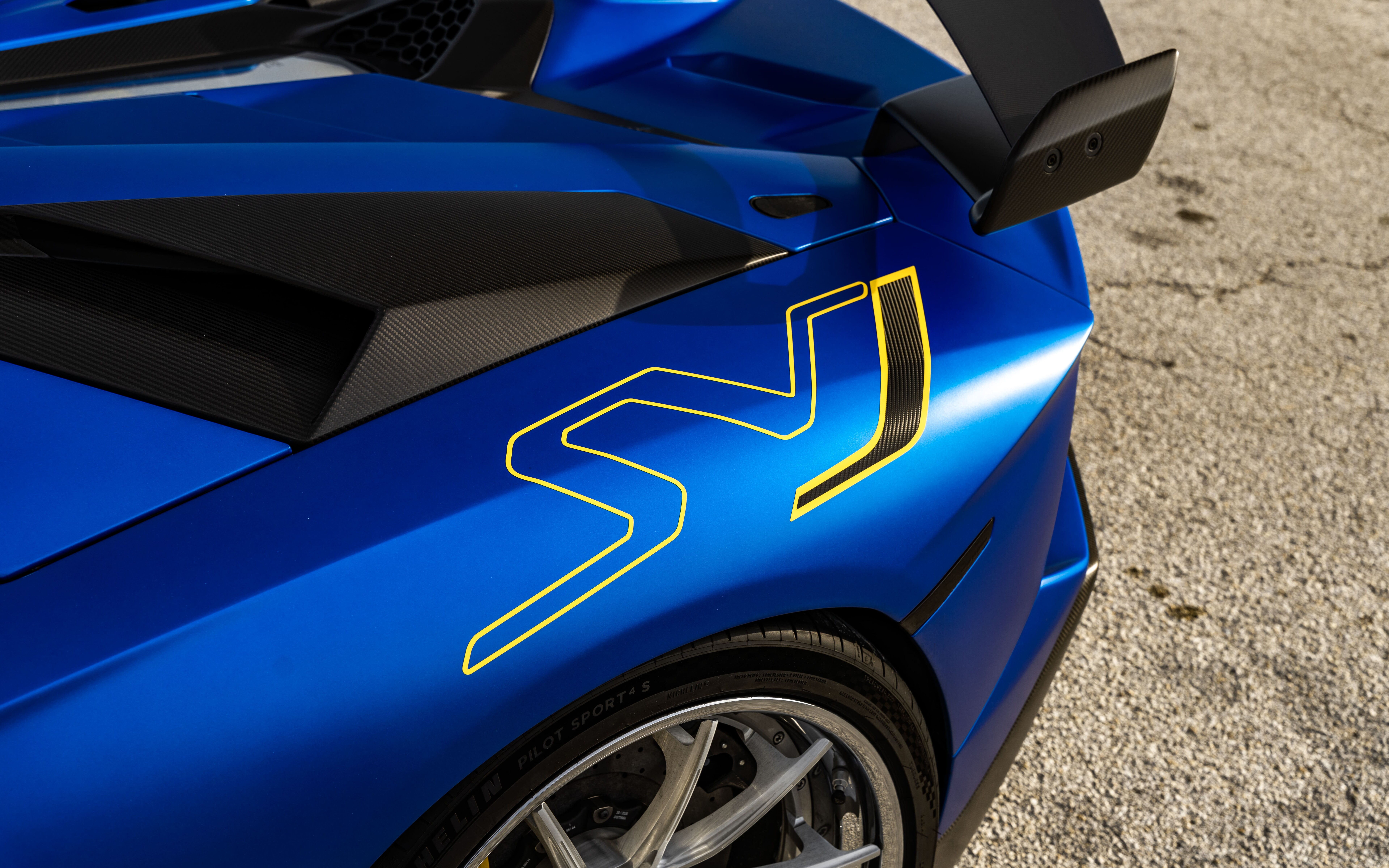 Um Lamborghini Aventador SVJ elegante e potente, com o seu característico design aerodinâmico e uma frente imponente.